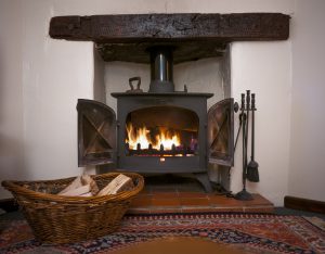 A Fireplace With A Wood Burning Stove